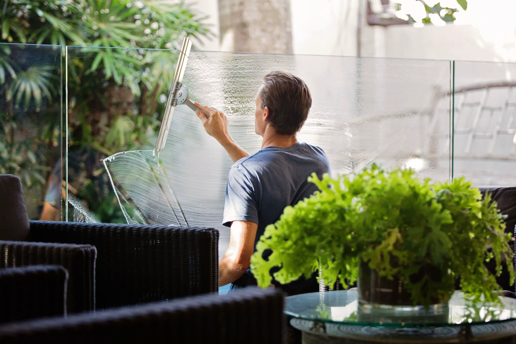 Stock image of glass cleaning beside a low-rise property