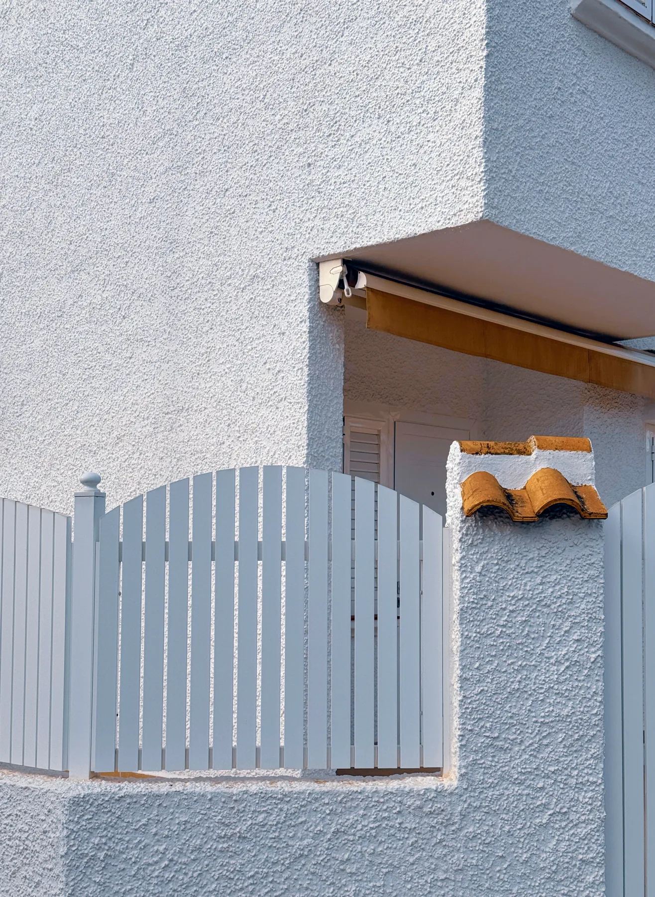 Rendered exterior wall and painted gate